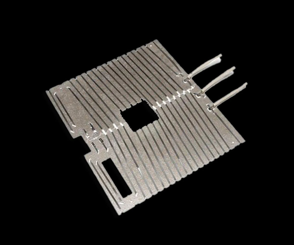 A flat mica surface heater cut to a platen shape, the foil track running in rows to three leads.